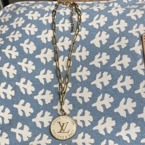 Louis Vuitton AUTHENTIC CHARM- with paper clip chain in gold tone.
